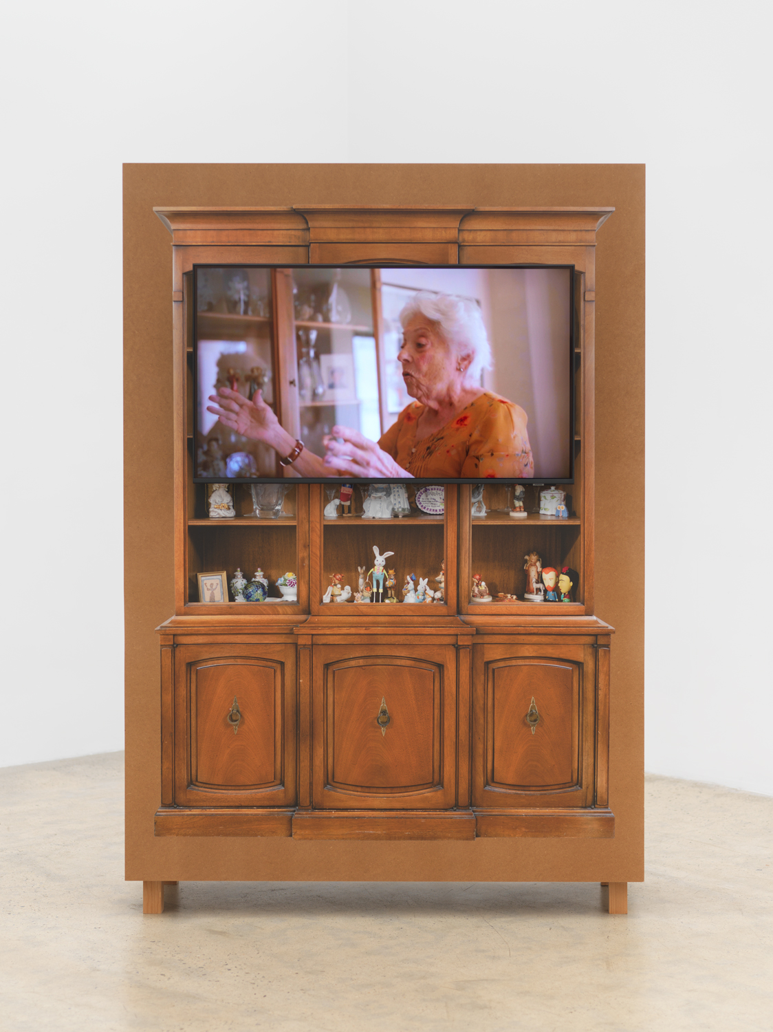 Matt Keegan, with shelves or drawers for storing or displaying, 2025, Clear-coat finished MDF, TV monitor, video, 76 3/4 x 52 3/4 x 17 3/4 in.