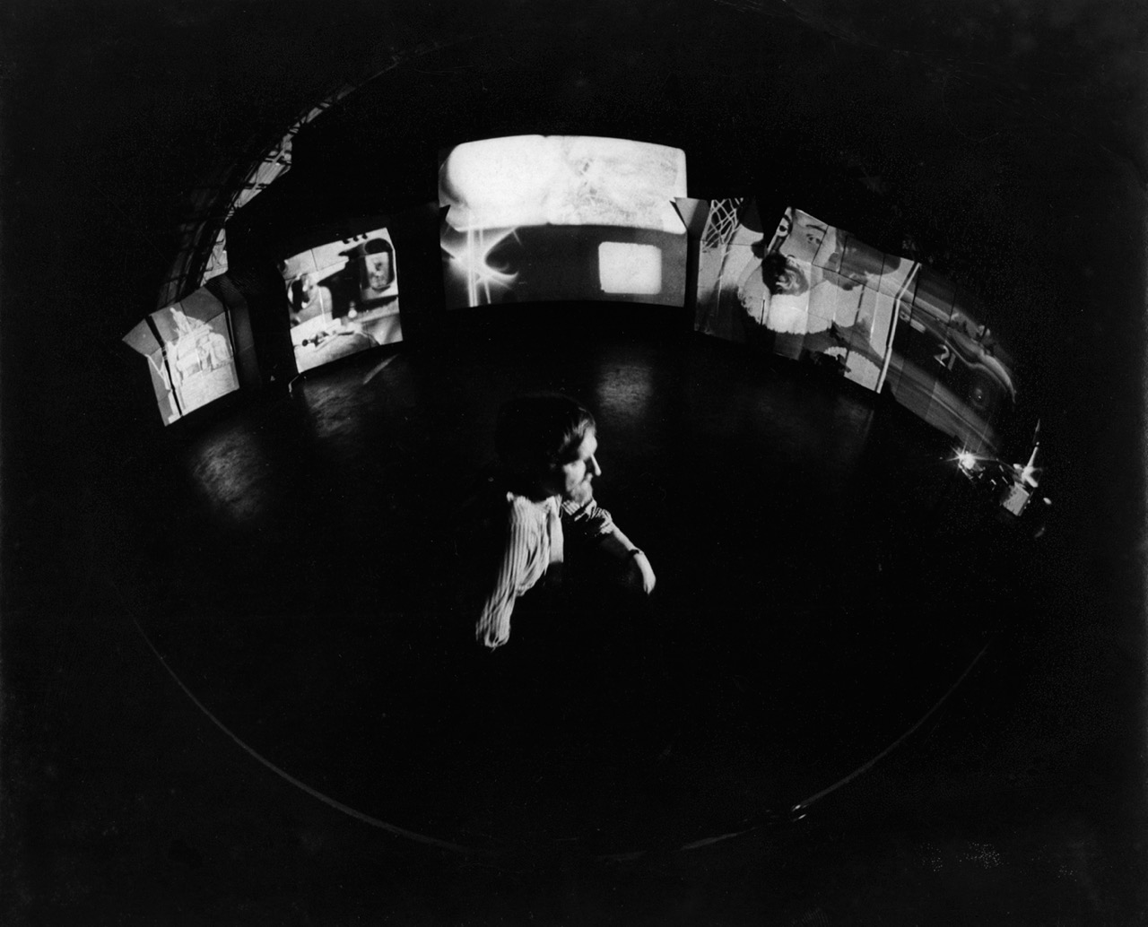 Stan VanDerBeek in front of Movie Mural. Installation view, Institute of Contemporary Art, Boston, MA, ca. 1968. Image courtesy of the Stan VanDerBeek Archive.