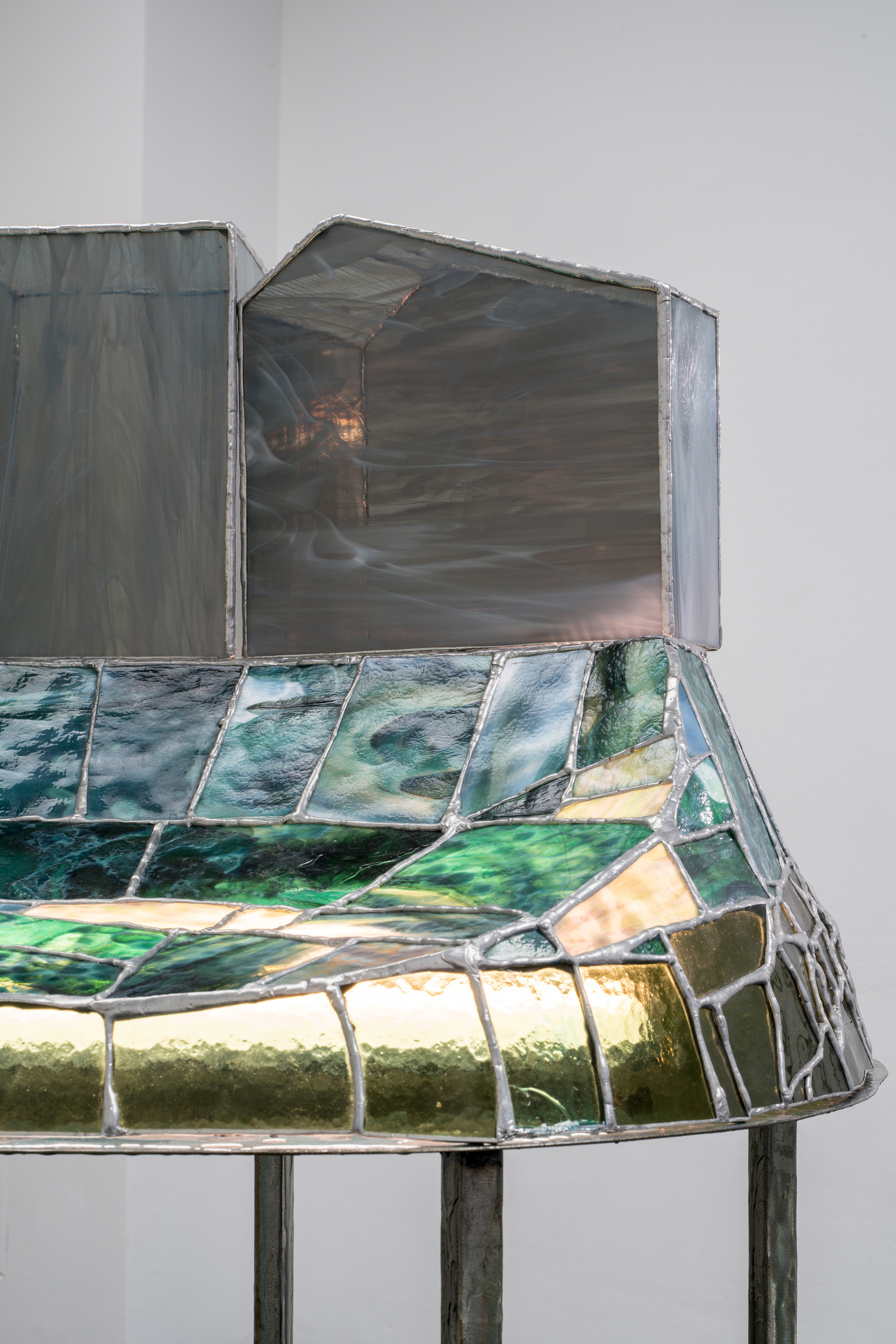 Tiril Hasselknippe, The Unfolding (table) (detail), 2021, Stained glass, tin, steel, light fixture, resin 49.21h × 48.42w × 22d in