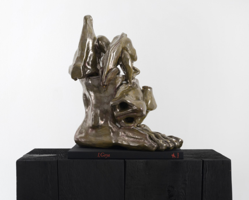 Nicolás Guagnini, The Bewitched Man, 2016, virtified glazed ceramic, book (I. Goya, Dagmar Feghelm, Prestel [2004]), 17.01h x 13.5w x 9.76d in.