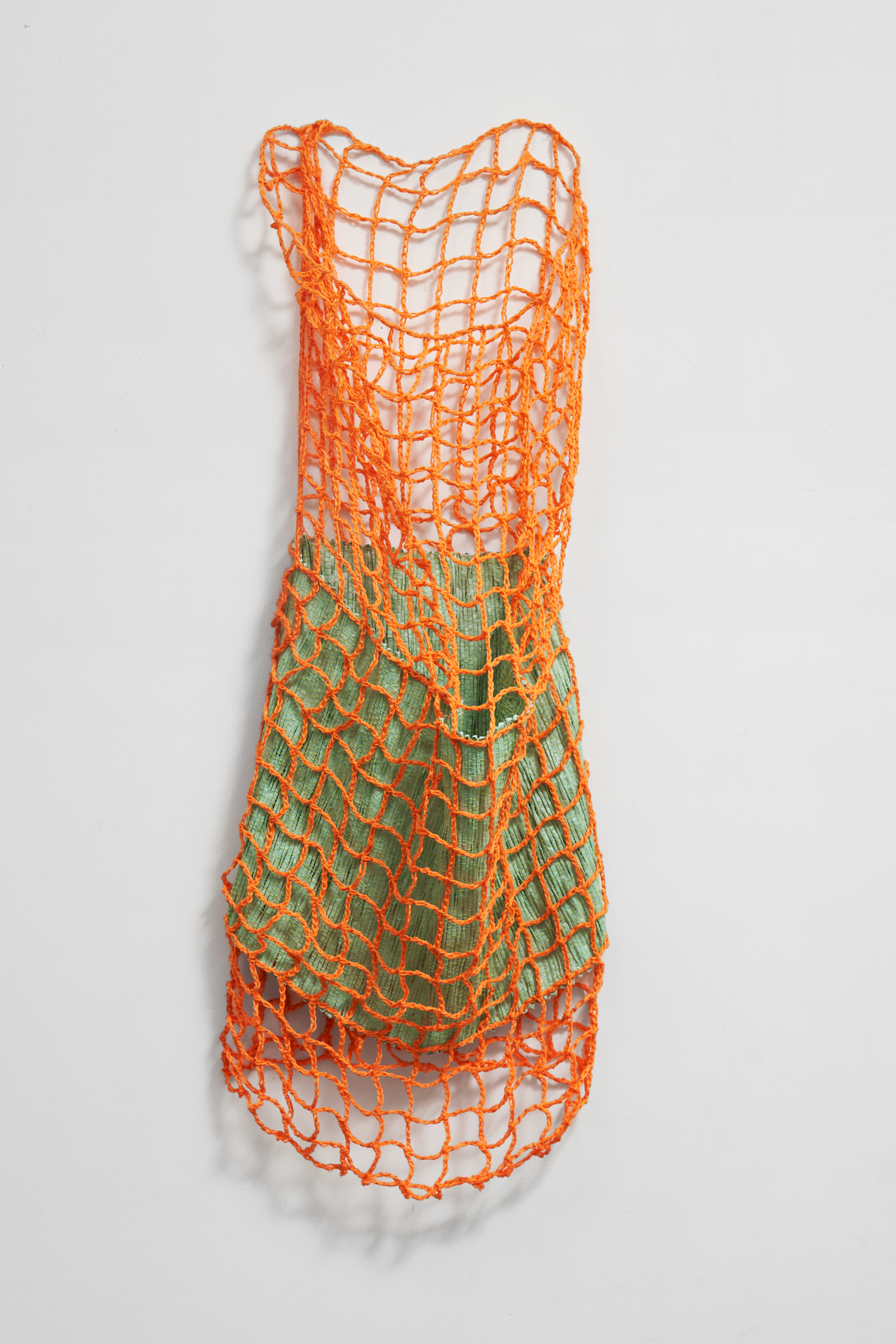 Hana Miletić, Materials, 2024, Crocheted and hand-woven textile (carrot orange organic linen, mint green organic wool, metal wire, and pale mint repurposed polyrattan), 46 7/16 x 17 5/16 x 10 5/8 in.