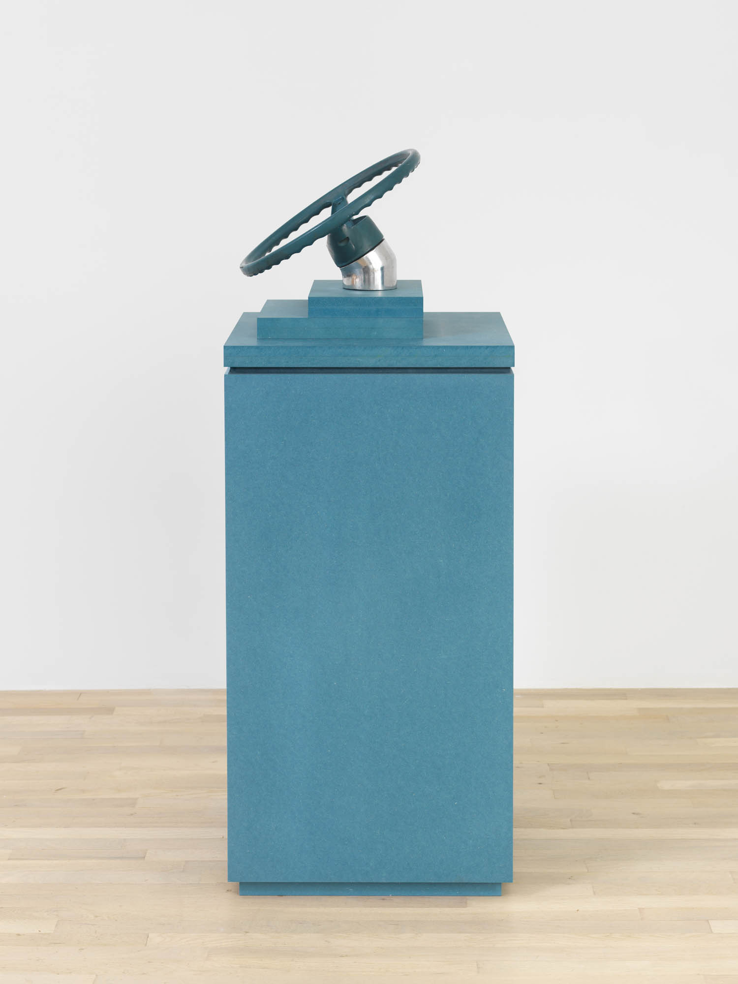 Jennifer Bolande, Circling Around, 2023, Steering wheel, blue pigmented high-density composite plinth and base, 52 1/4 x 20 x 20 in.