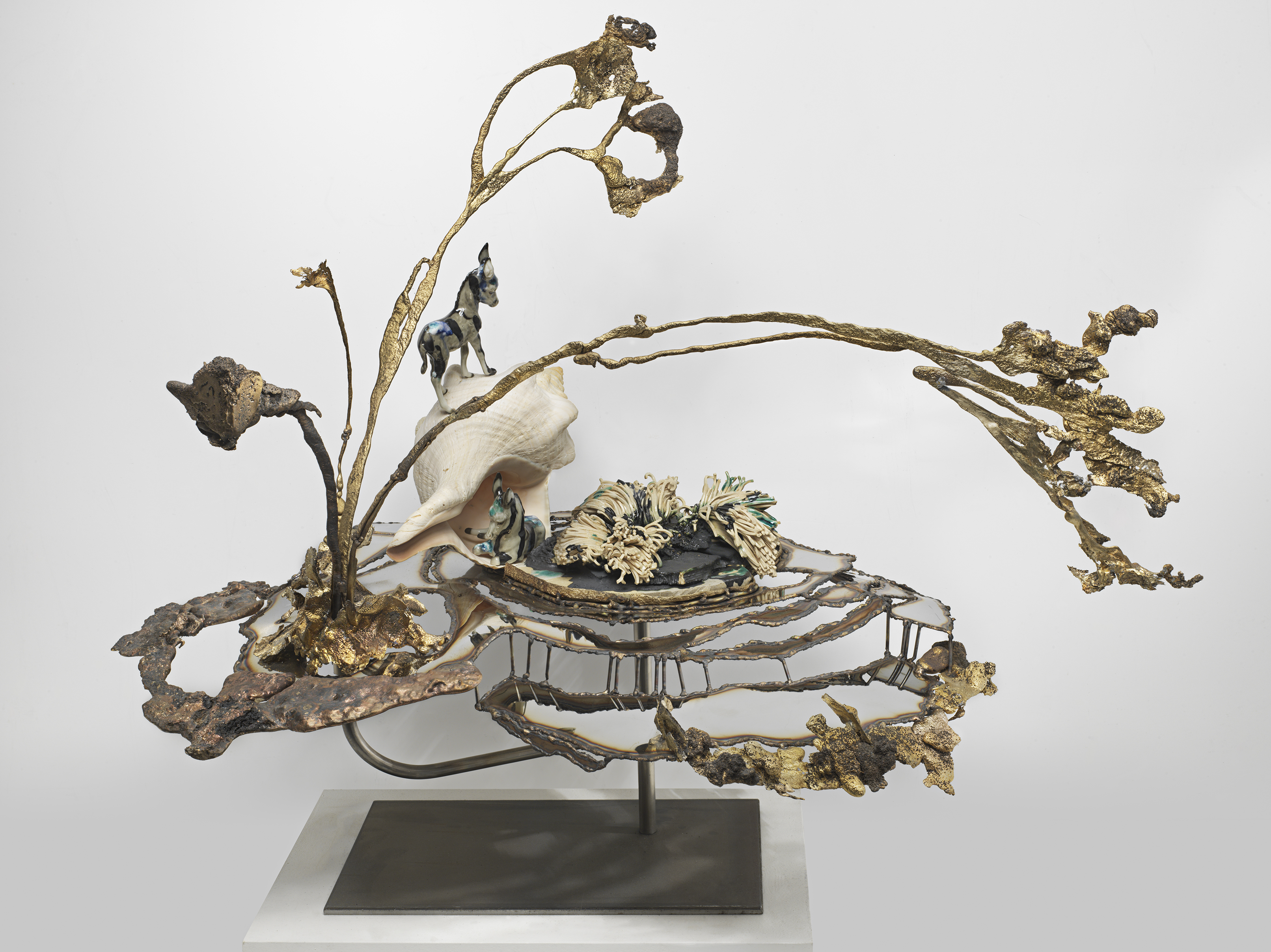 Jon Kessler, Lagoon, 2024, Stainless steel, bronze, copper, glazed stoneware, shell and porcelain figurines, 31 x 32 x 24 in.