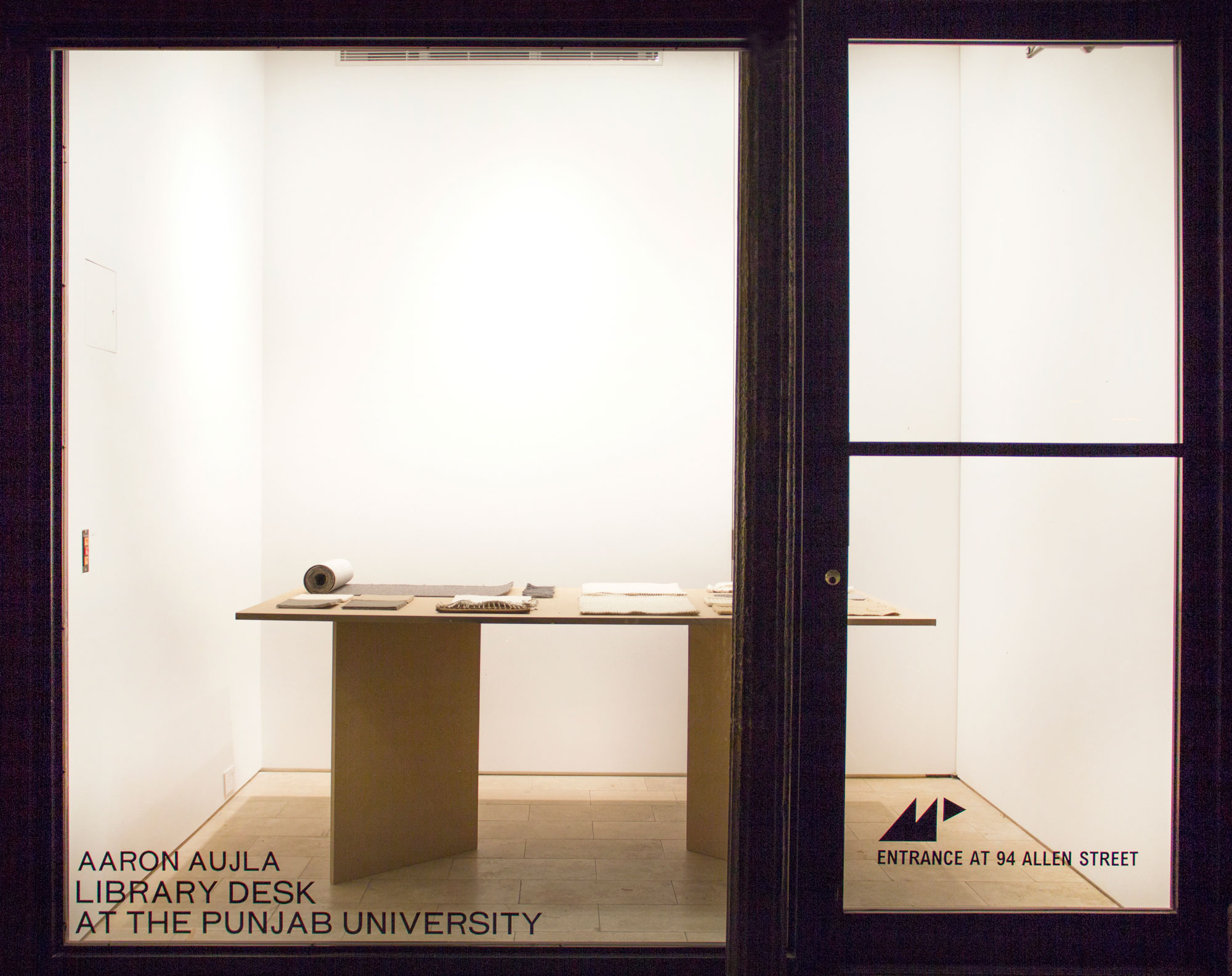 Aaron Aujla, Library Desk at The Punjab University, 2016, industrially-produced fiber carpet samples, handmade carpeting by Textile Arts Center fiber artisans, MDF desk, 72h x 36w x 29d in.