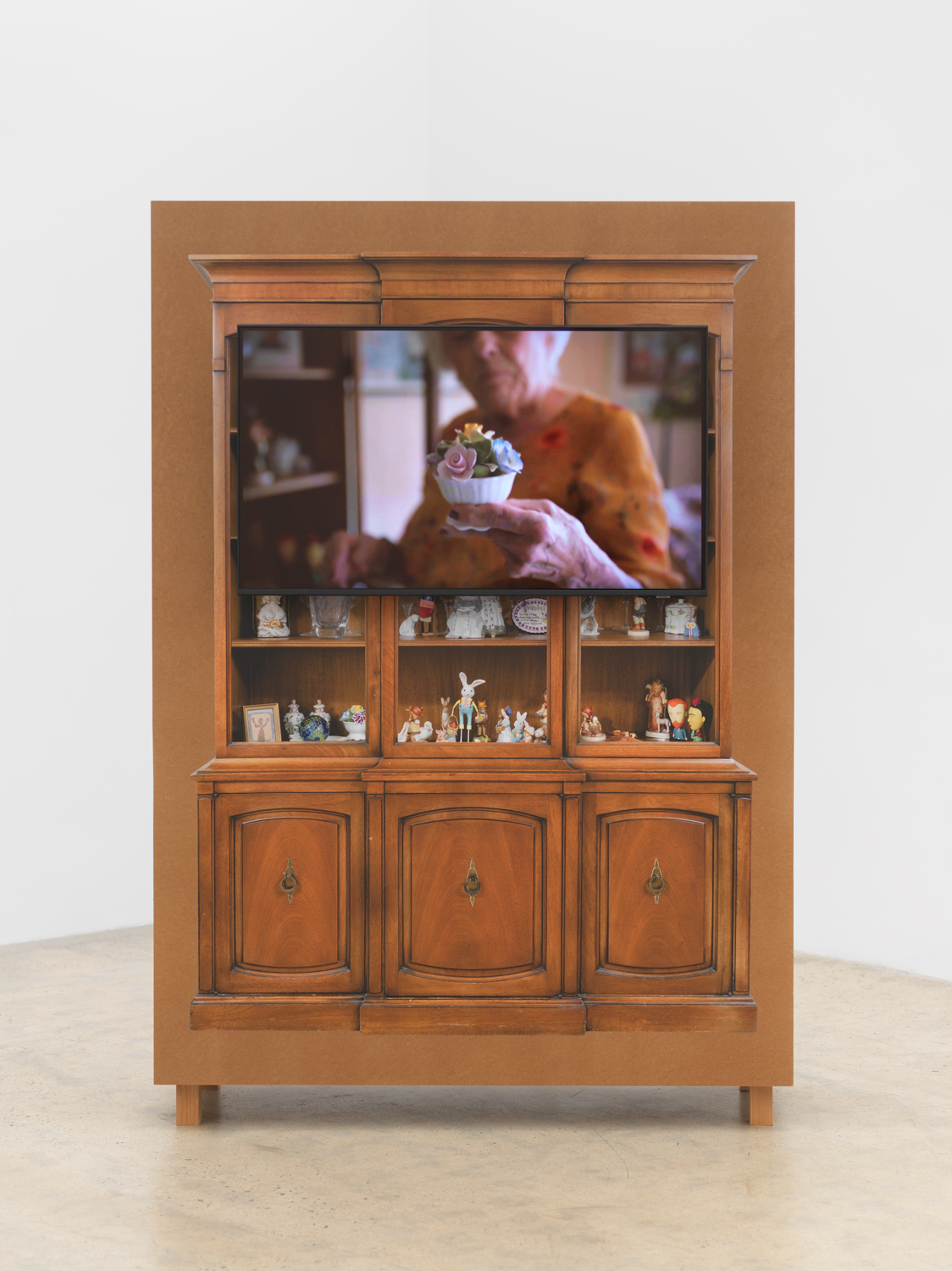 Matt Keegan, with shelves or drawers for storing or displaying, 2025, Clear-coat finished MDF, TV monitor, video, 76 3/4 x 52 3/4 x 17 3/4 in.