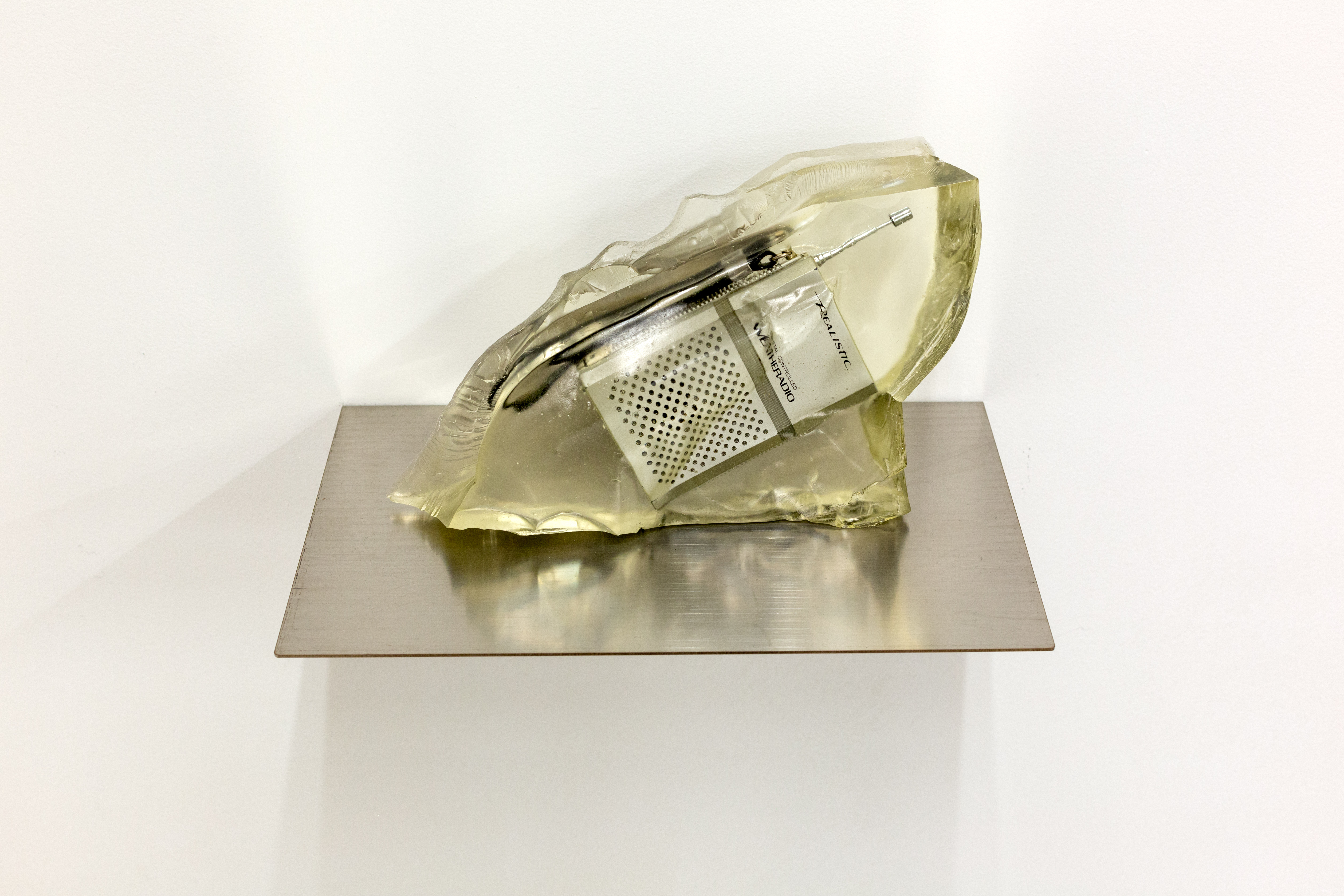 Daniella Dooling, Realistic Weather Radio, 2019, Realistic weather radio embedded in resin, 6h x 8.50w x 2.25d in.