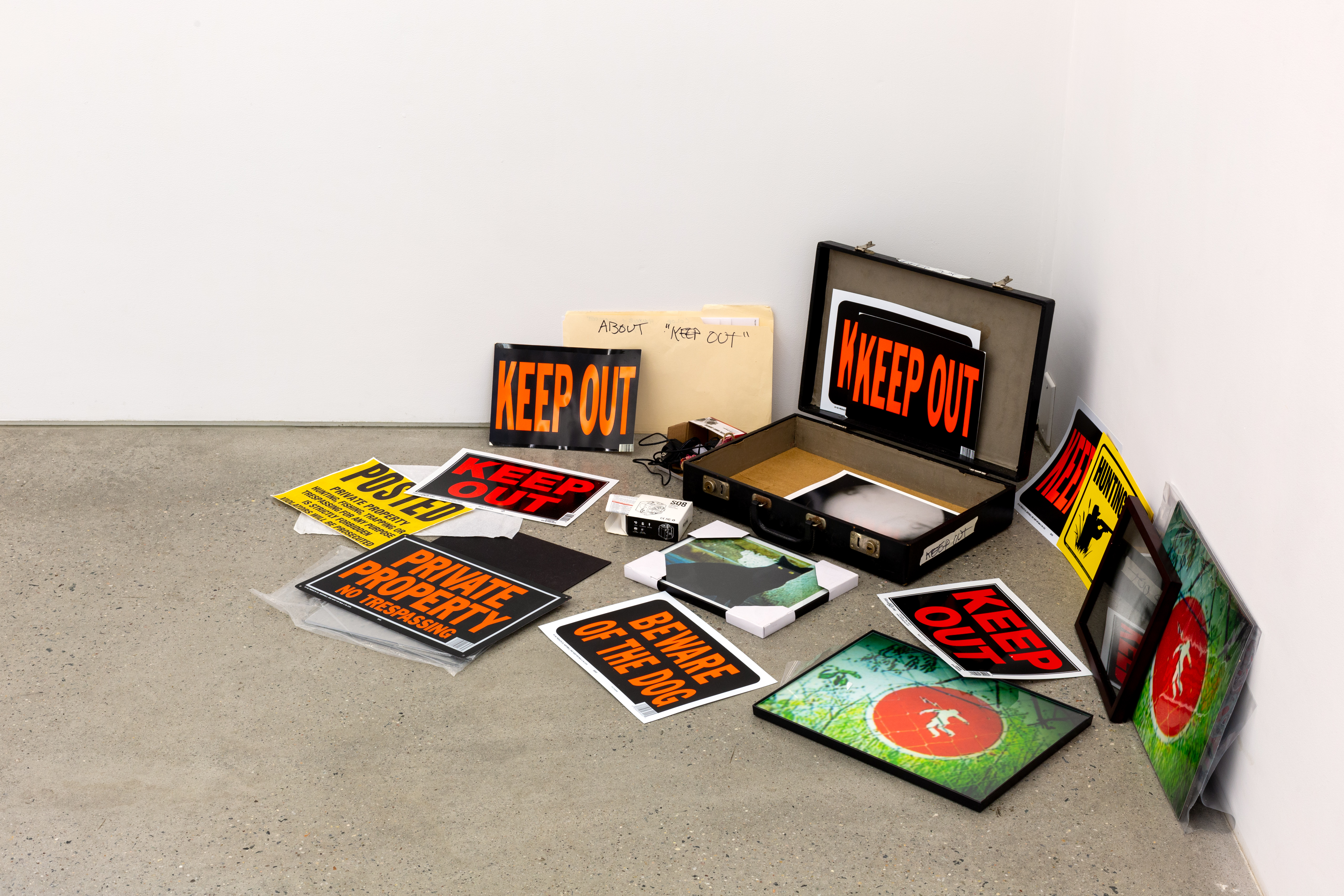 Barbara Ess, Keep Out, 2017, Suitcase, framed photographs, beware signs, mirror, security camera, etc., Dimensions variable.